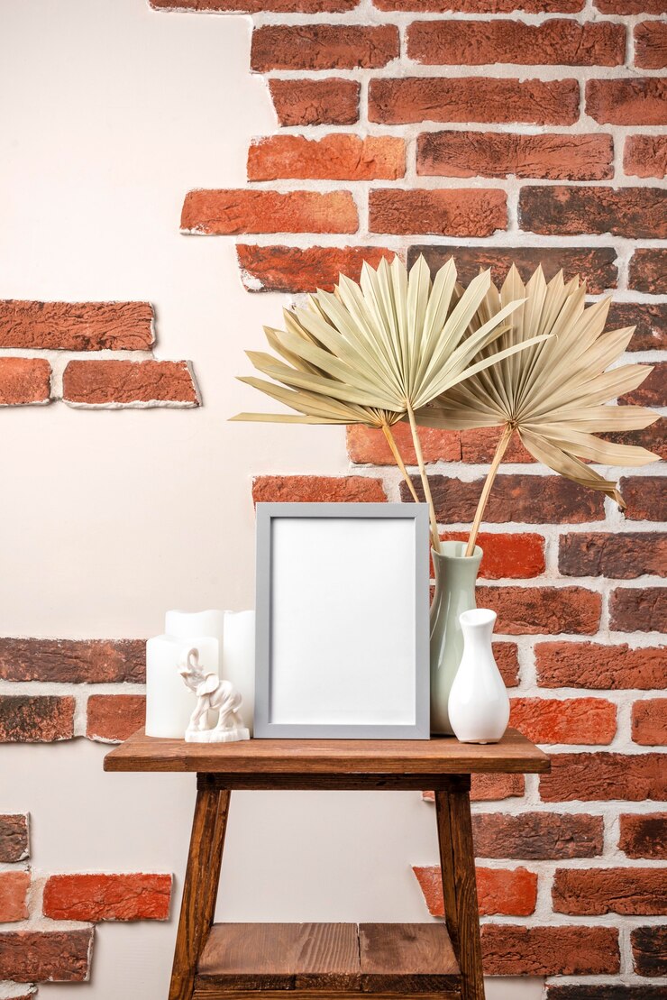 blank-frame-shelf-beside-vase-with-dry-leaves_23-2148875373